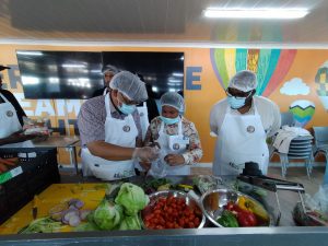 Minister Meyer being shown an example of vegetable processing while Dr Mogale Sebopetsa looks on