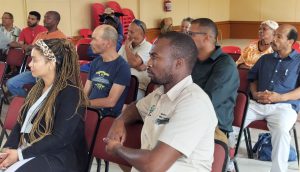 Group of small scale farmers listening attentively to Minister Meyer