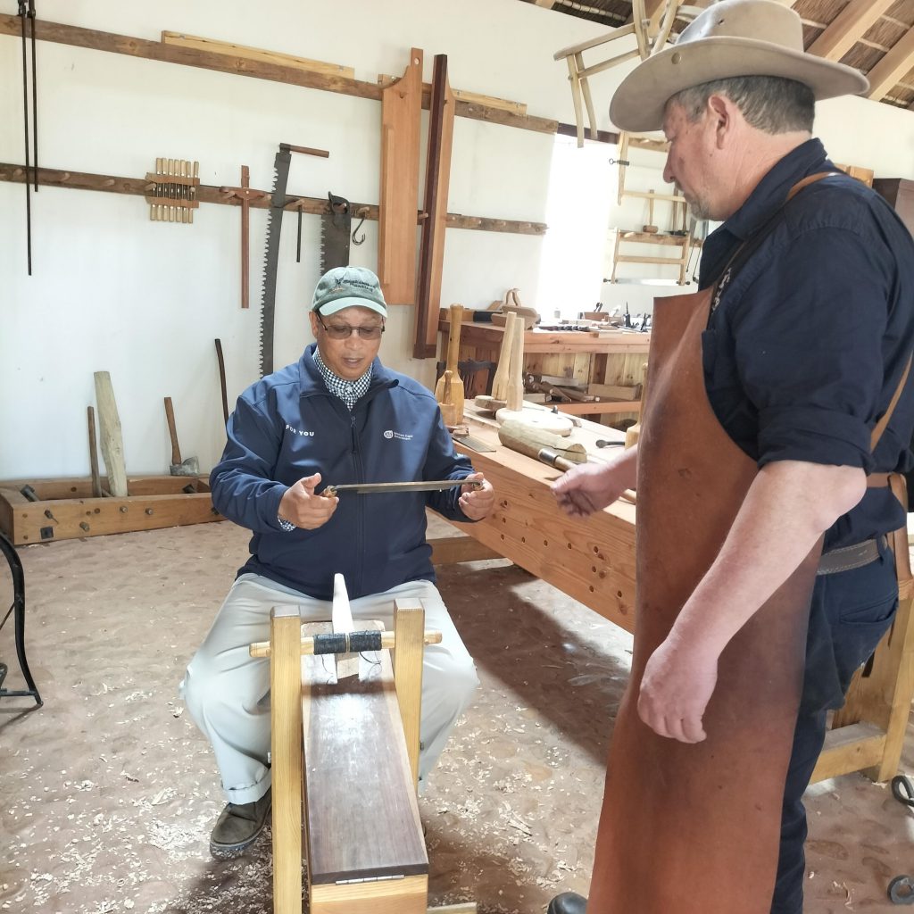 Minister Meyer trying his hand at oldfashioned carpentry