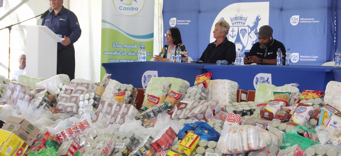 Minister Meyer addressing audience at WFD with food mountain the foreground